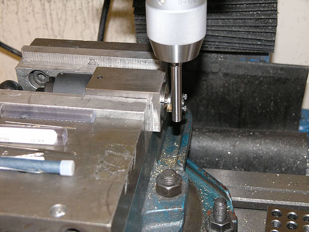 Metalworking machine with drill bit and surrounding tools.