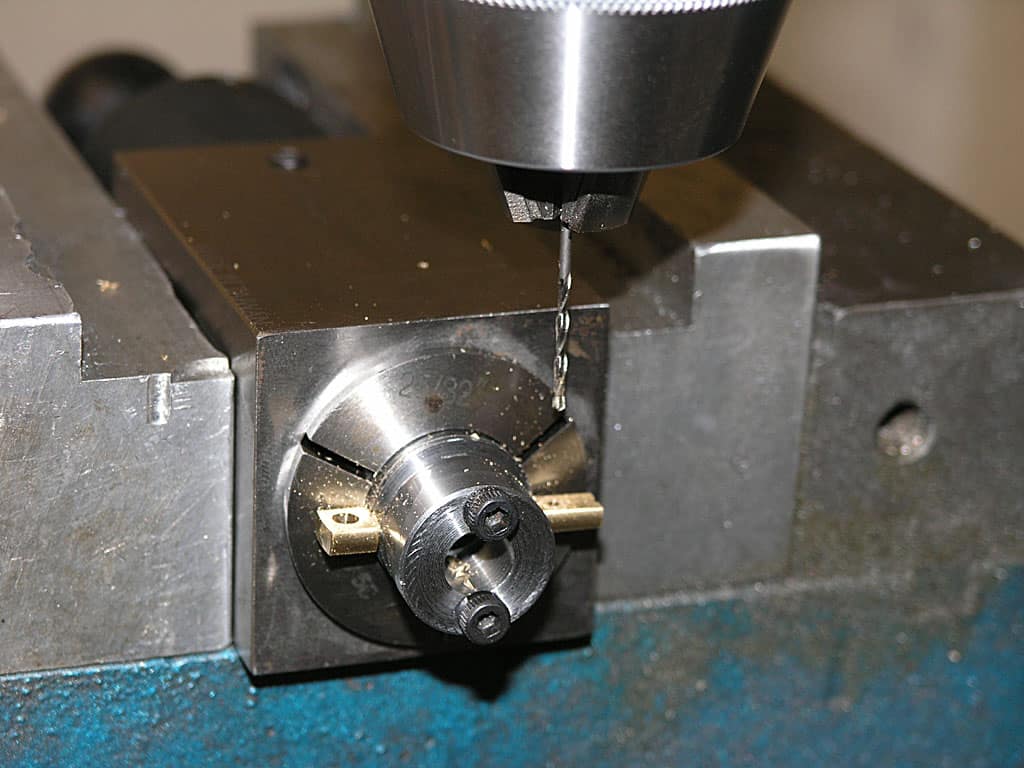 Metalworking tool, likely a drill bit, on a workbench.