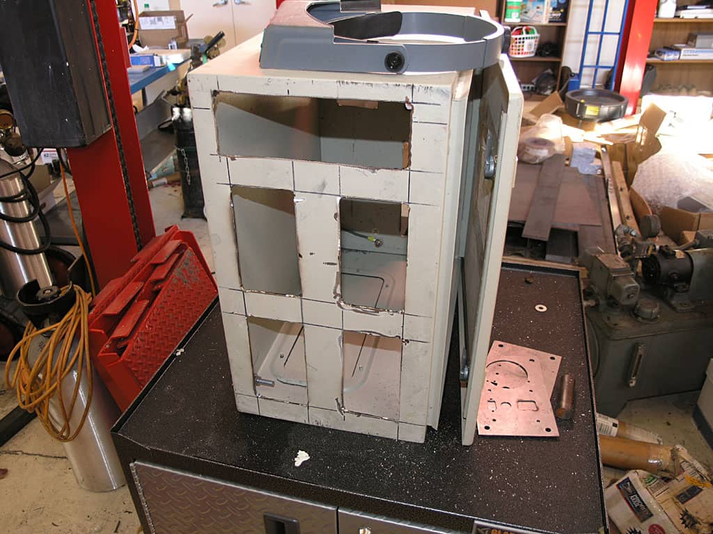 Partially disassembled metal device on black box.