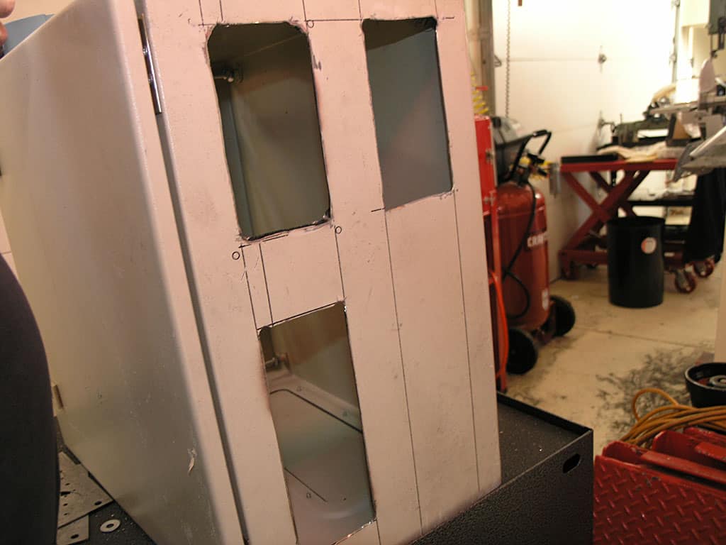 Partially constructed metal structure in a workshop setting.