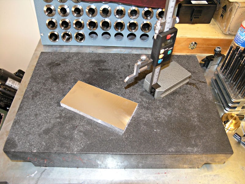 Precision measuring tool on a workbench in a machining shop setting.