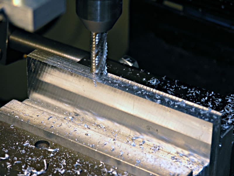 Metalworking process in action, featuring machinery and manufacturing environment.