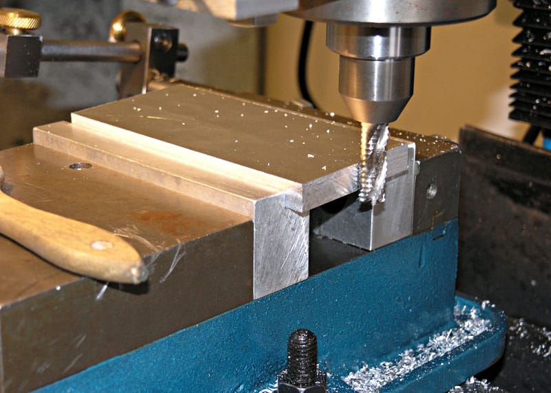 Metalworking lathe or milling machine with spindle, collet, and cutting tools.