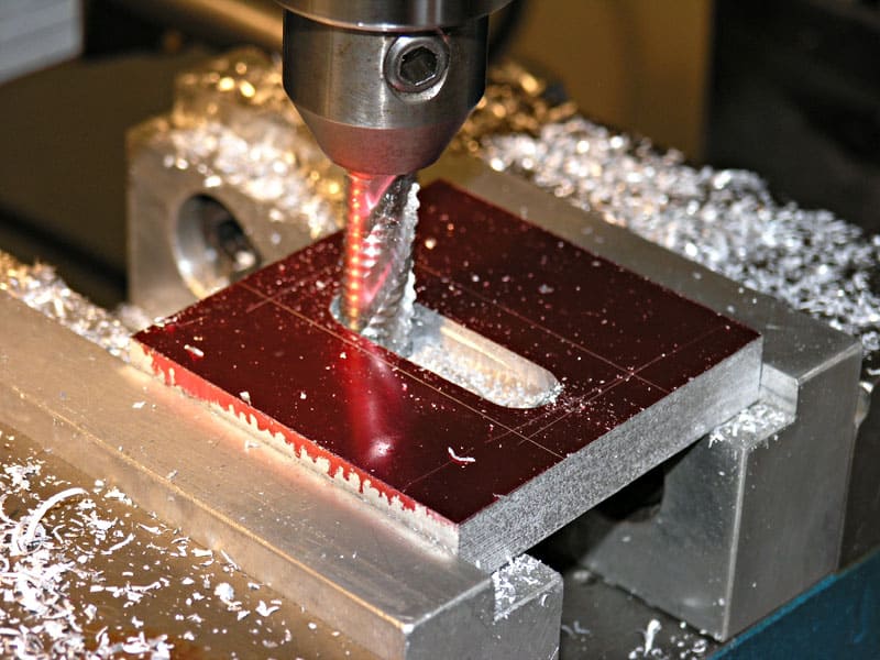 Metalworking machine with attached cutting tool and metal shavings.