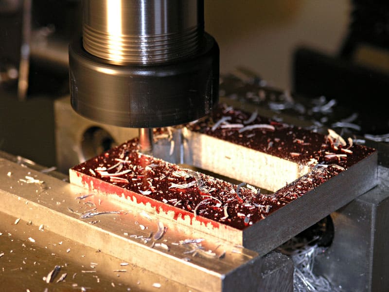 Metalworking machine tool with cutting tool and shavings.