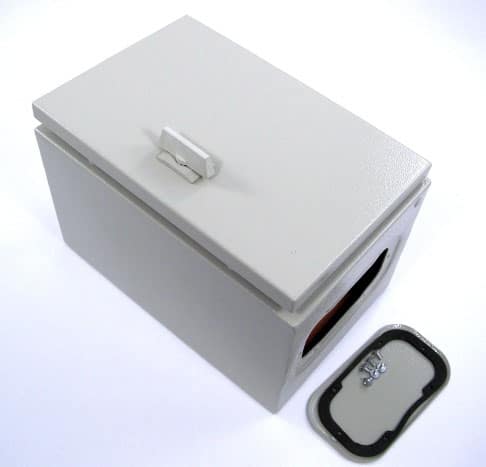 Small white plastic box with rectangular shape and rounded corners, featuring a latch and a silver metal object inside a sealed opening.