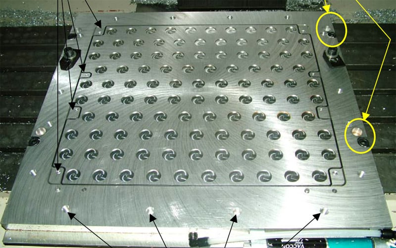 Vacuum table with varied-sized circular holes.