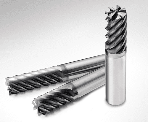 Silver metal cutting tools with spiral flutes, positioned at an angle on a white surface.