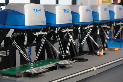 Three TBS machines on a gray table.