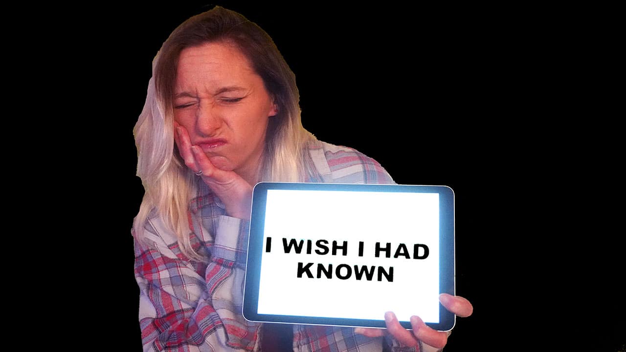 Woman holding tablet with black text on white screen, against gray background.