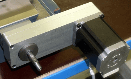 Metal component with cylindrical protrusion and flat surface.