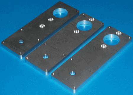 A rectangular piece of metal with three circular holes at an angle on a blue background, with a silver aluminum or stainless steel finish.