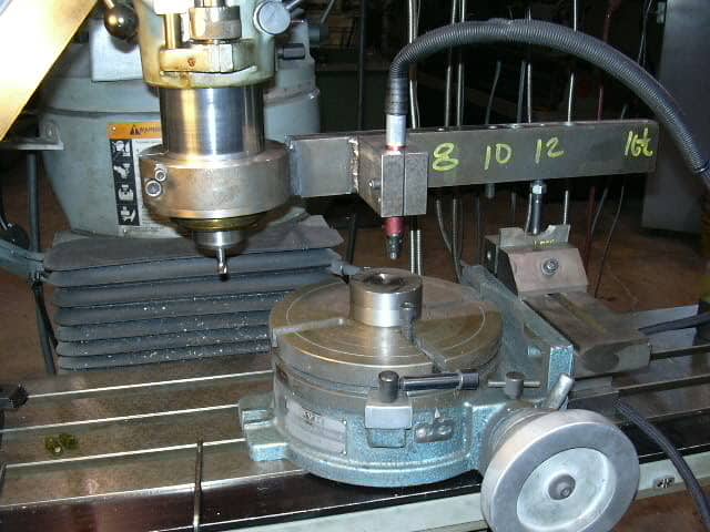 Large metalworking machine with spindle arm and milling head.