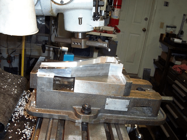 Large metal milling machine in a workshop setting.