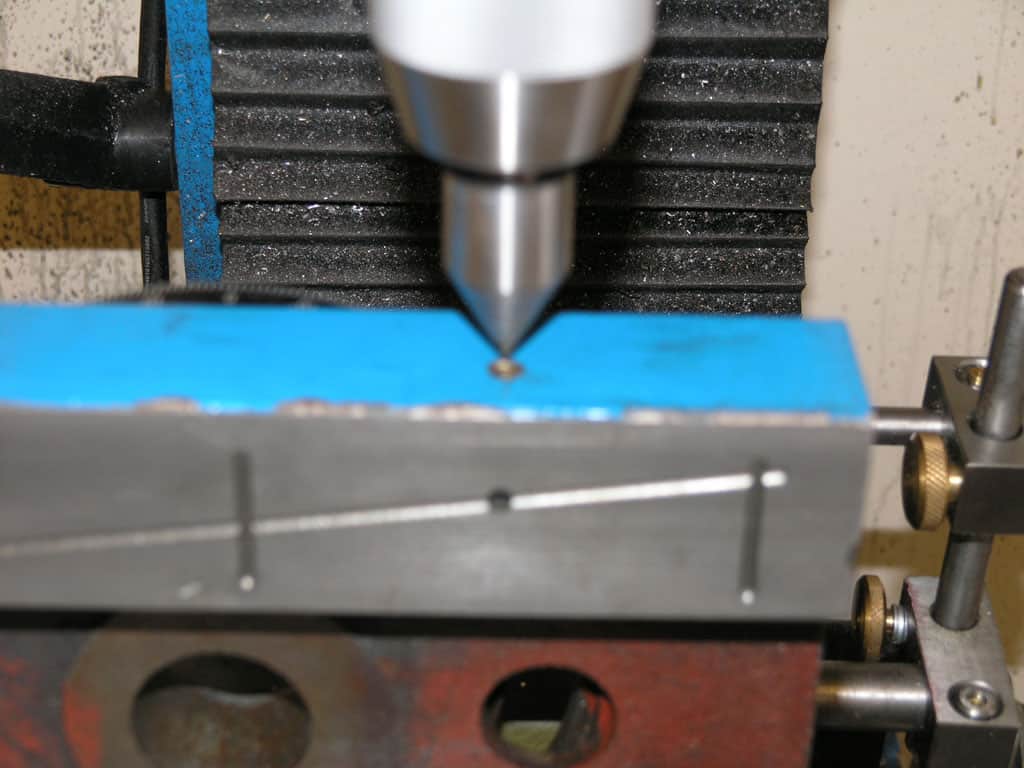 Metalworking tool with blue component in a machining or metal fabrication context.