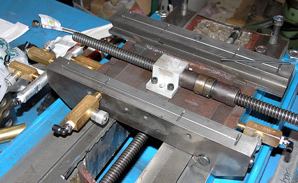 A sturdy metal vise on a workbench, with adjustable jaws and robust frame.