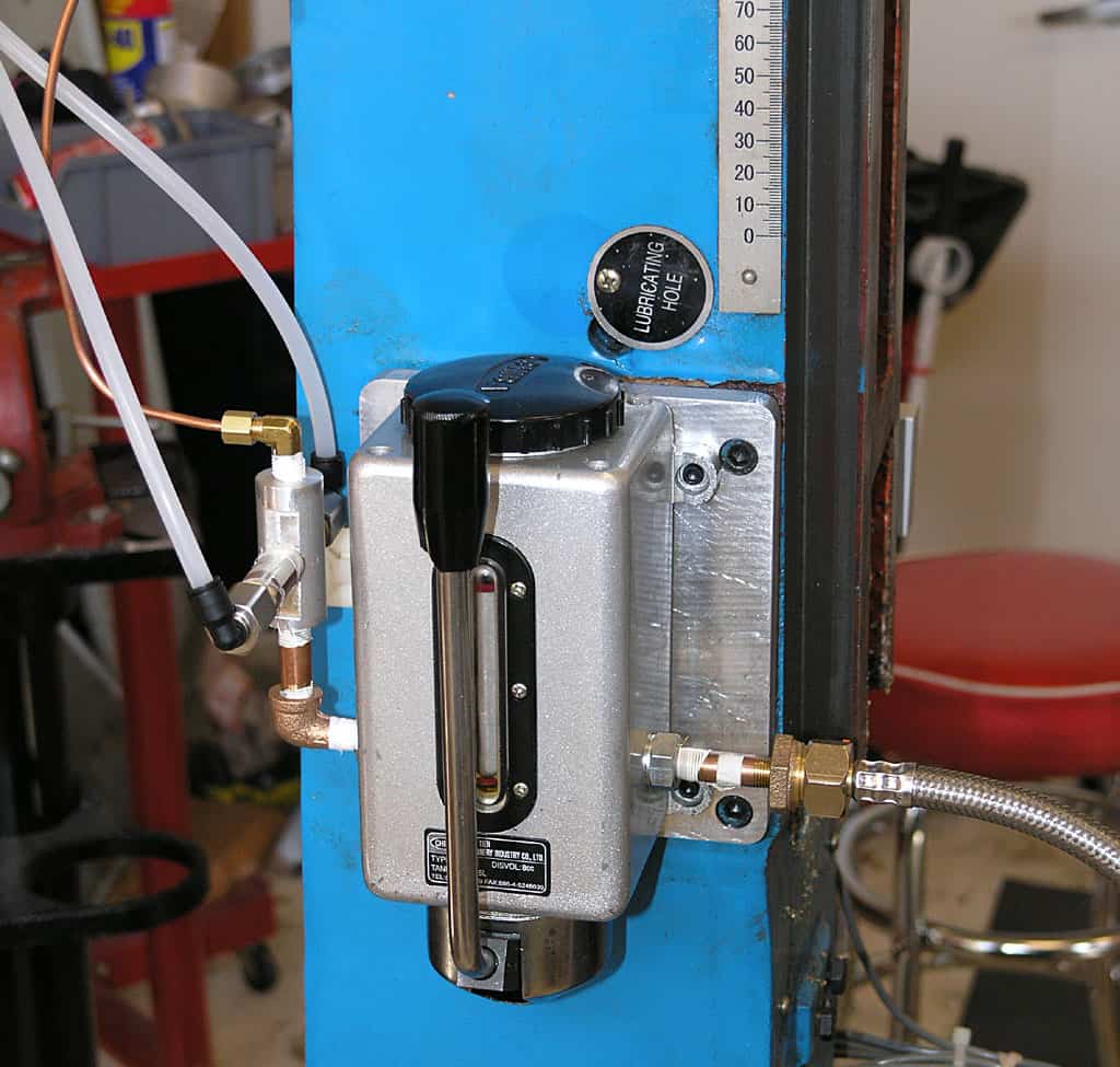Metal device in workshop/machine shop setting with tubes, wires, and dials.