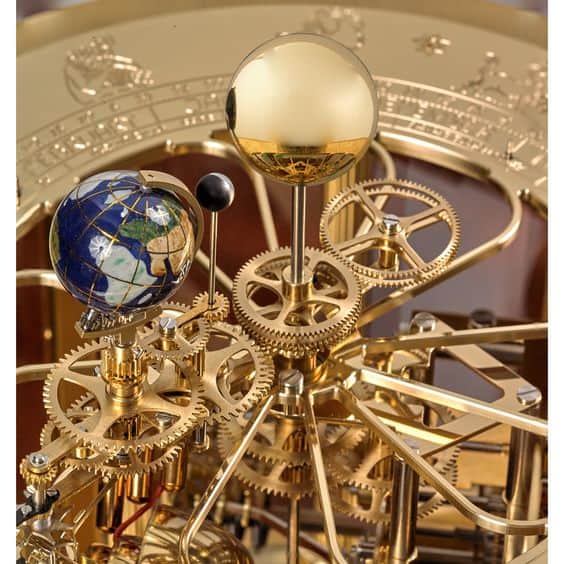 Mechanical model of the solar system with intricate brass gears and celestial bodies.