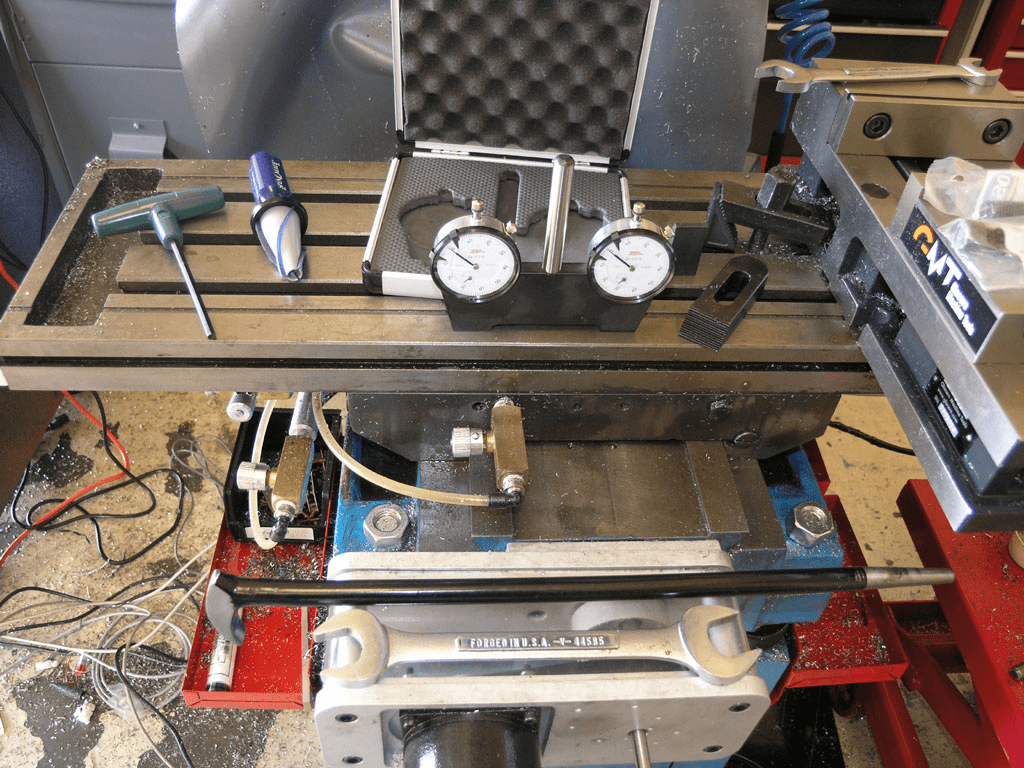 Well-organized machine shop workbench with tools and equipment.