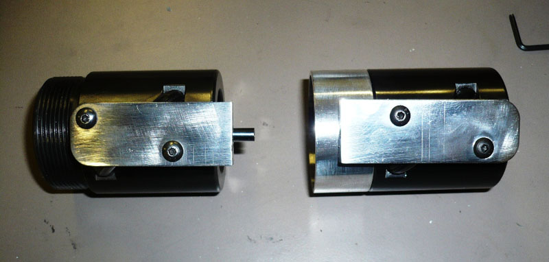 Three cylindrical metal components with black and silver finishes.