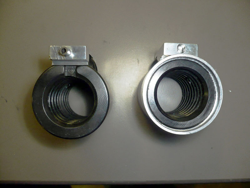 Cylindrical metal components with threaded interiors.