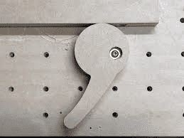 Metal pegboard with small keyhole on right side.