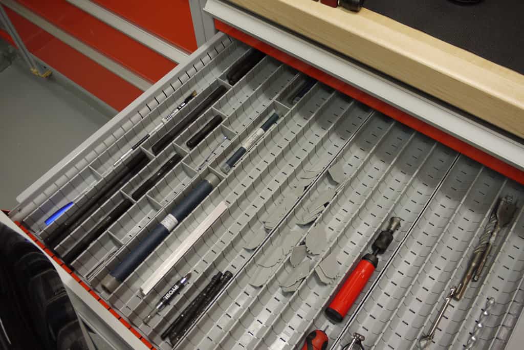 Photograph of organized tool chest contents for machining and metalworking.