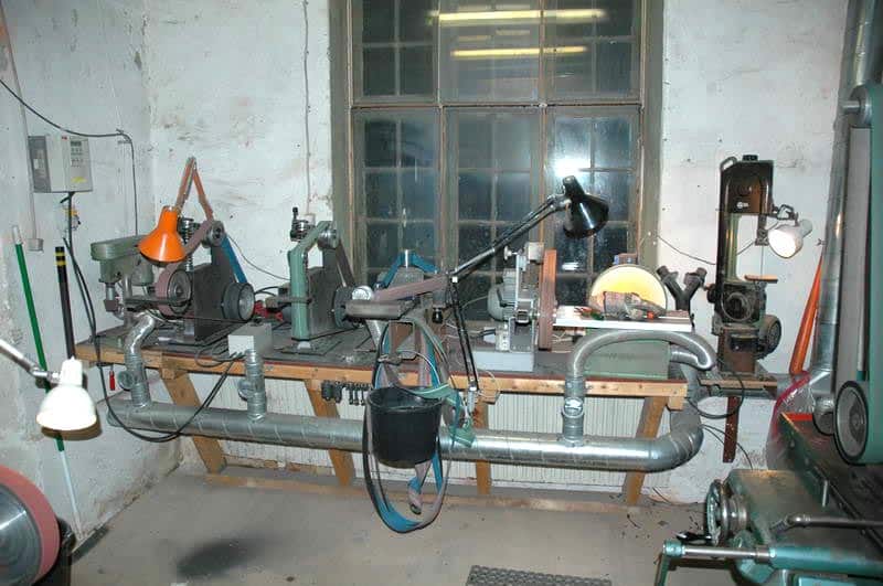 Well-organized workshop with lathe, mill, grinder, and drill press.