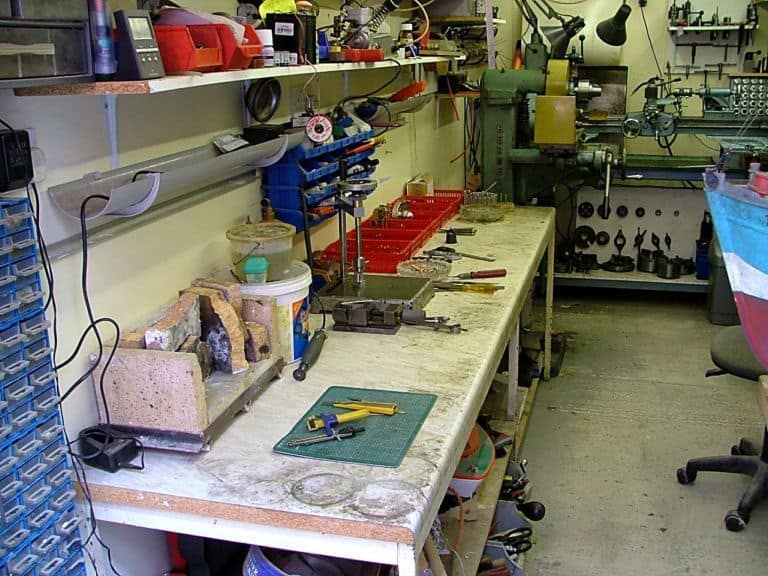 Cluttered workshop with various tools and equipment.