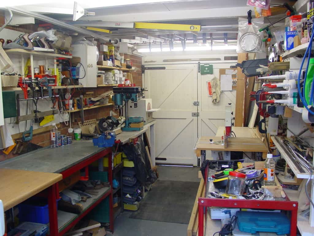 A cluttered yet organized workshop with various machining tools and equipment.