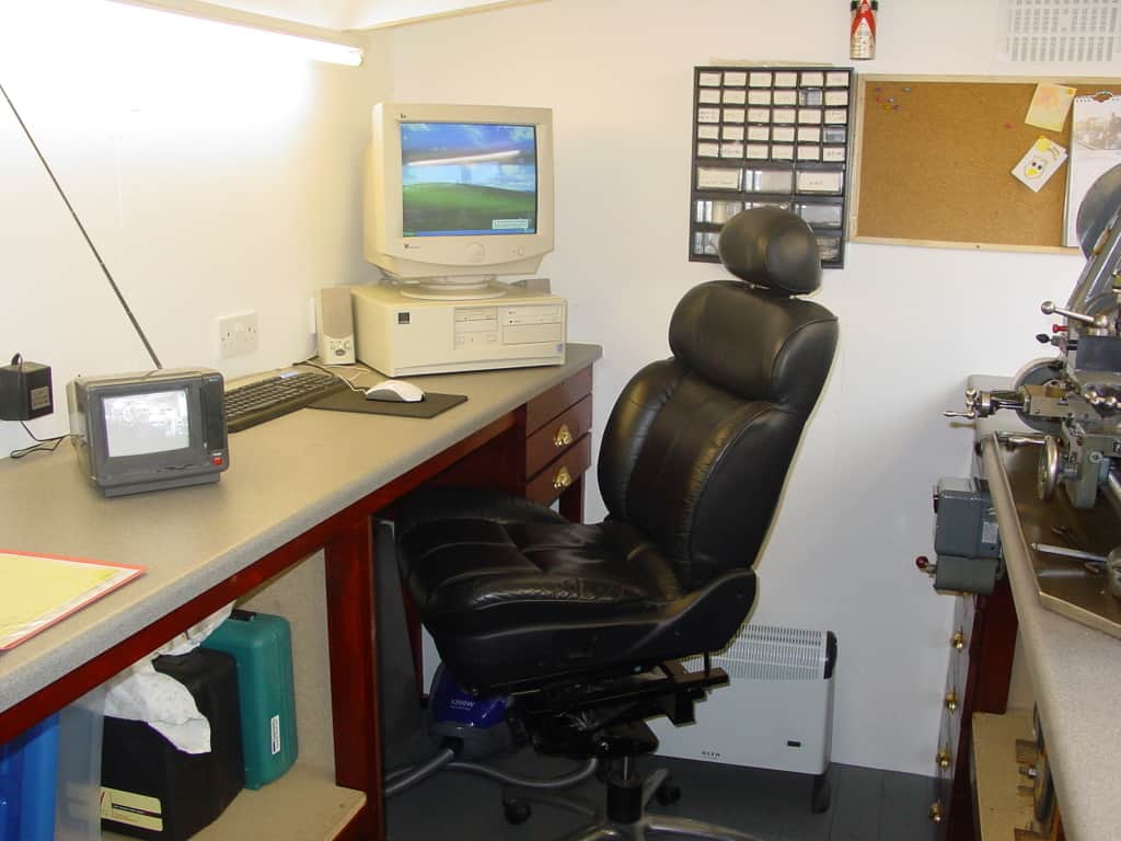 Small office or workshop interior with a computer station on a desk.