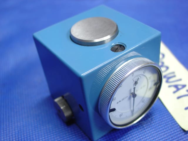 Blue device with circular dial and knob.