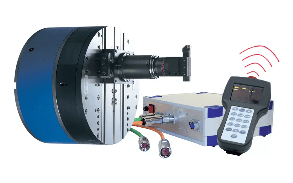 Cylindrical device with black top and blue bottom, connected to silver box with wires, on white background.