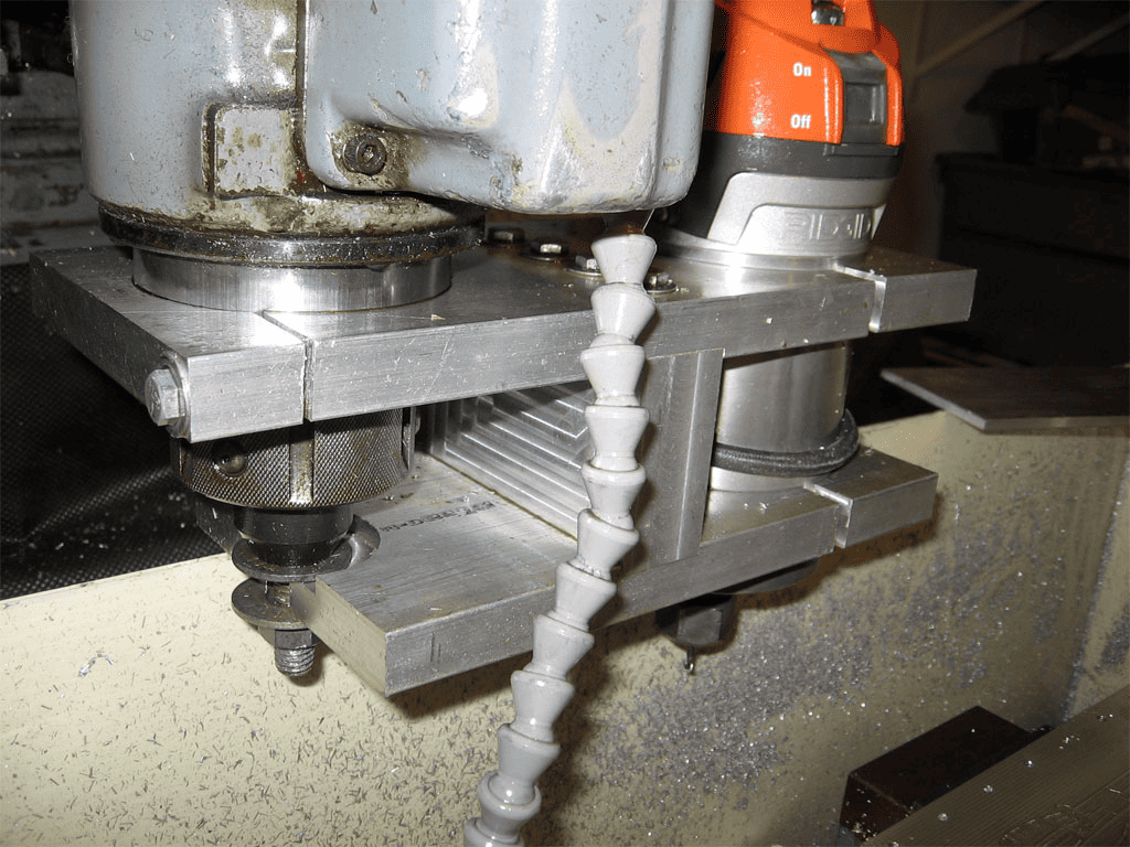 Metalworking machine tool with orange handle and spiral object in process.