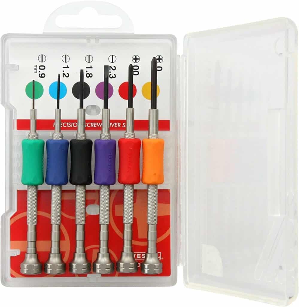 Precision screwdrivers with colored handles in various tip sizes, displayed on a white background in a clear plastic case.