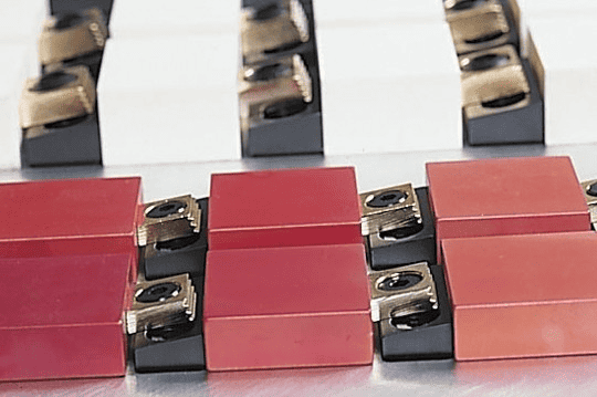 Red electrical connectors with metal prongs.