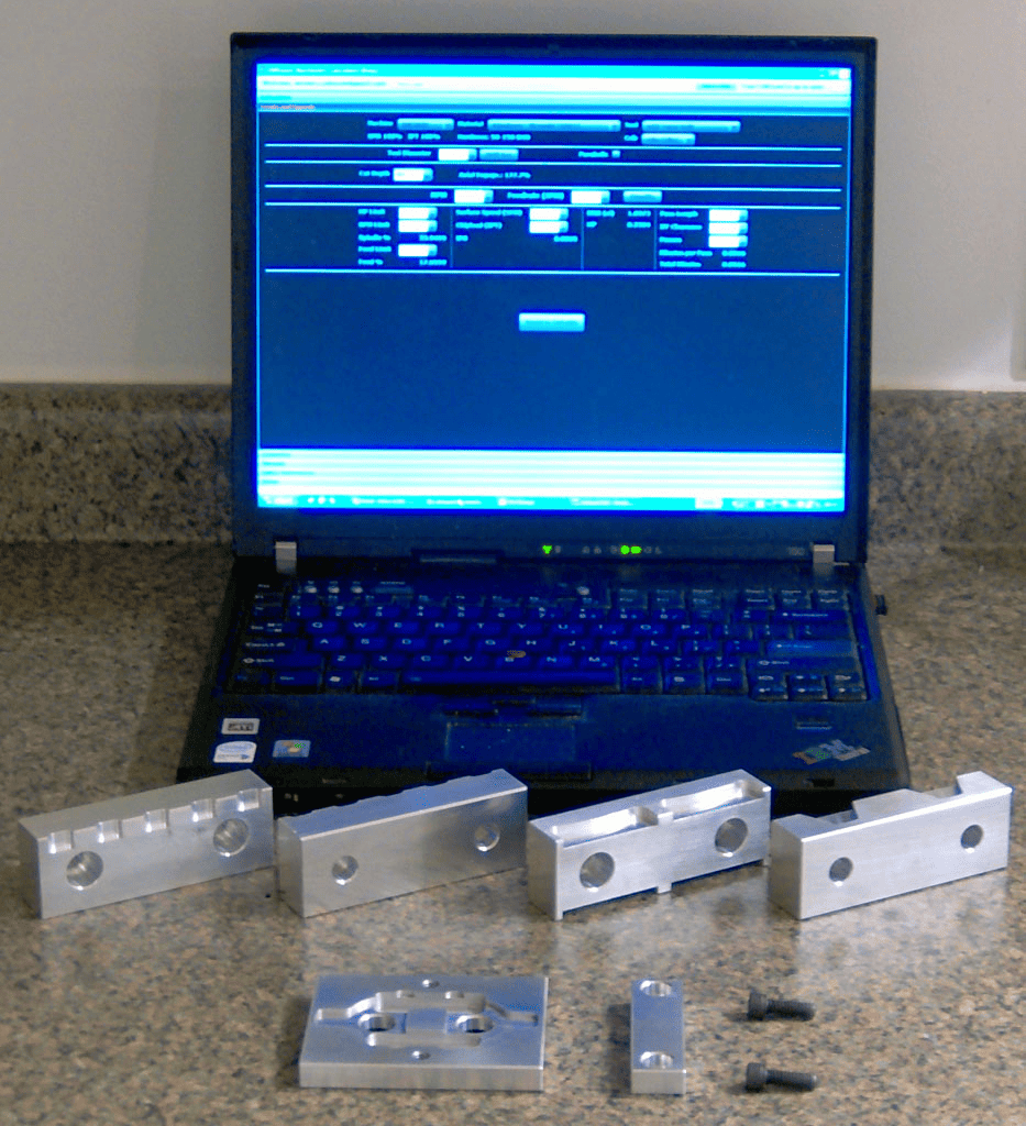 Black laptop on granite countertop with metal parts.