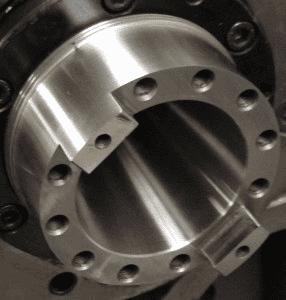 Metal component with cylindrical shape and circular holes.