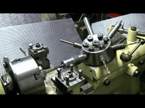 Close-up of a metal lathe or milling machine with metal components.