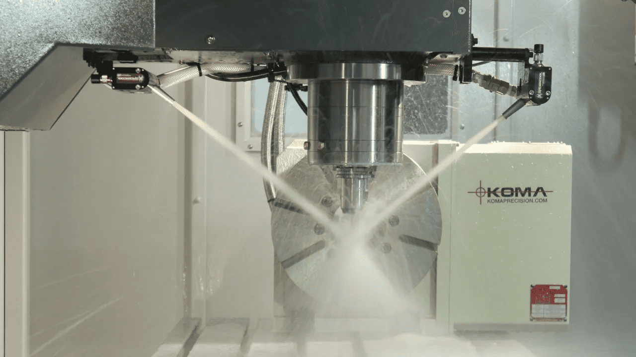 Koma Komaprecision.com CNC machining equipment with two metal tubes and black control box.