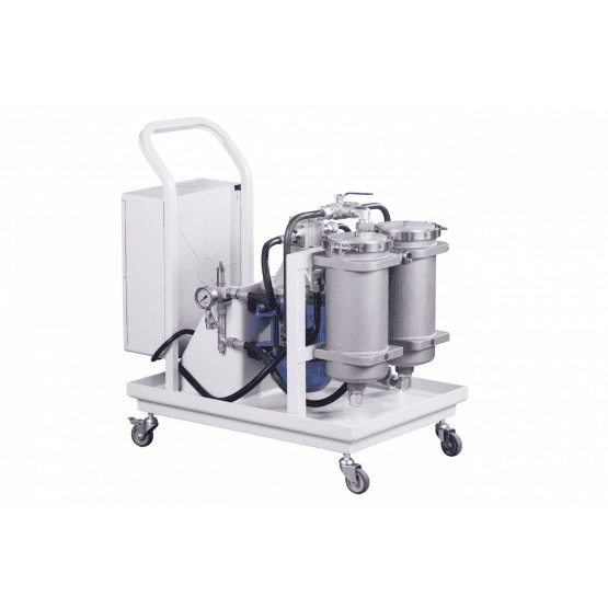 Stainless steel tank with two containers and large cylindrical object on white platform.