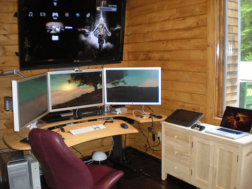 Home office workspace with multiple computers.