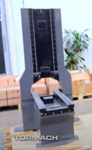 A large, tall, rectangular frame with black surface and silver edges, featuring angled sides and small holes.