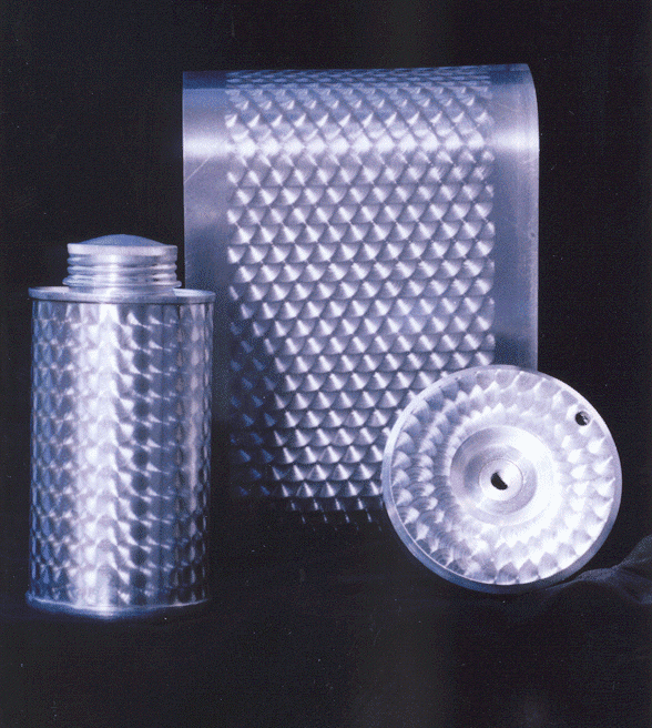 Metallic cylindrical objects with diamond-shaped patterns, arranged on a black background.