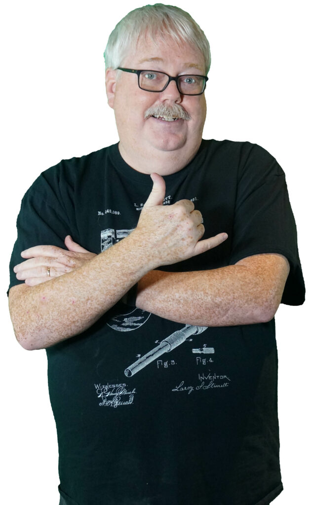 Middle-aged man with short white hair, black t-shirt, and Pipe Wrench Co. logo, giving thumbs-up gesture.